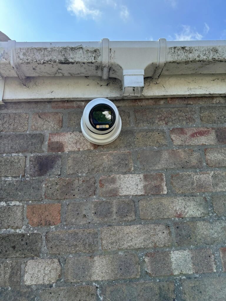 An installation of a security camera on the outside of someone's premises