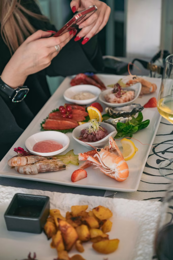 A delectable seafood platter with varied gourmet offerings, photographed stylishly in Cervia, Italy.